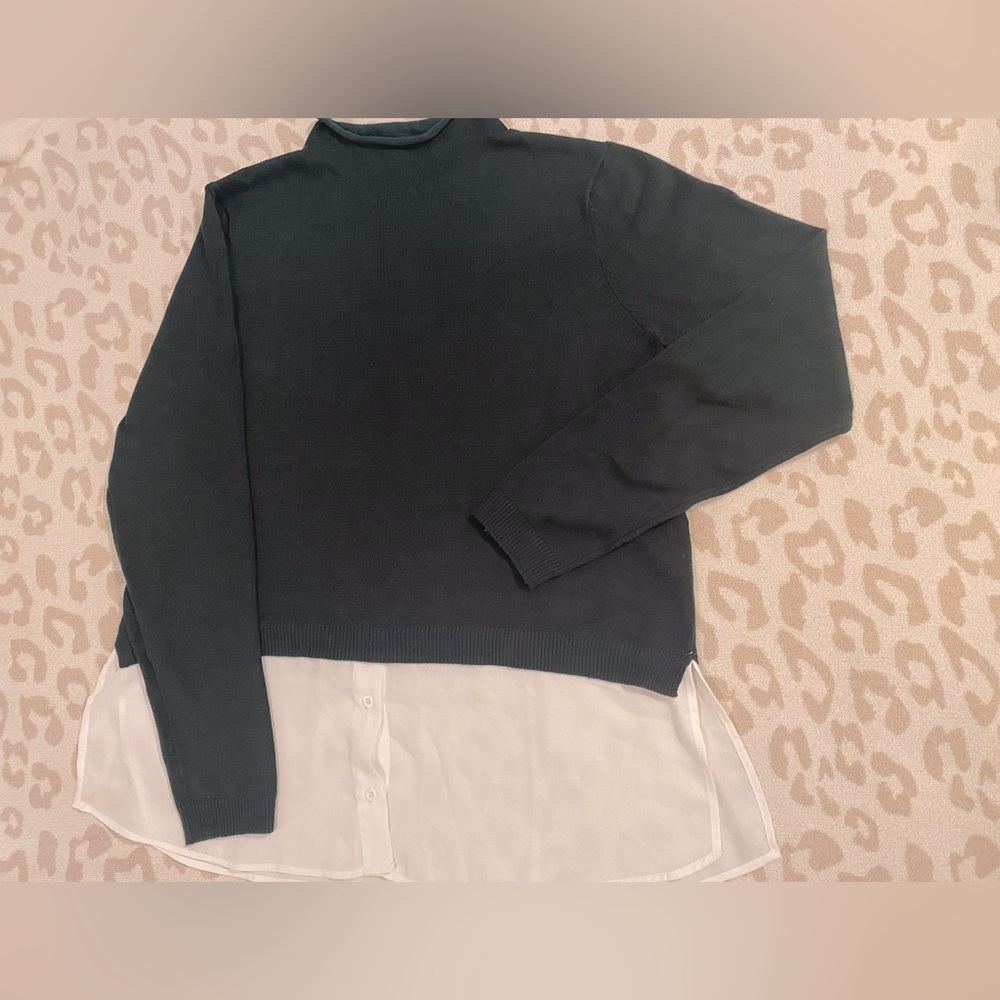 Green sweater with white shirt tales